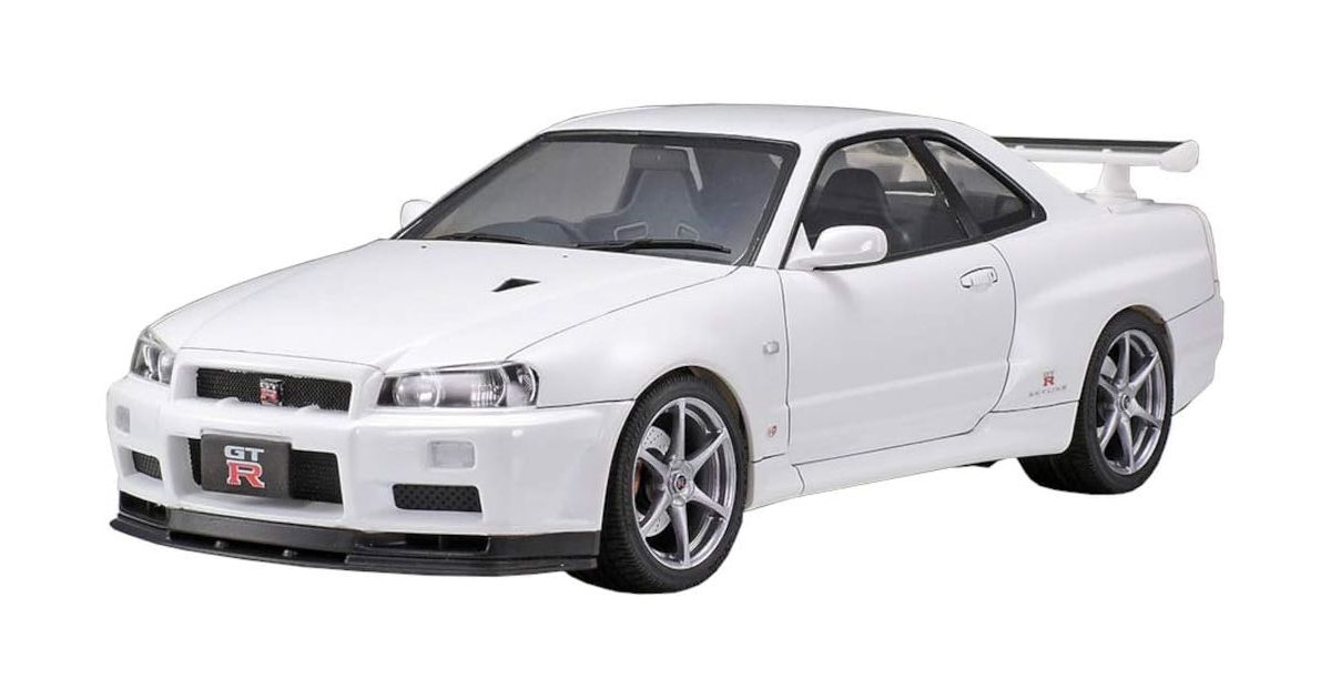 Nissan Skyline GT-R V-SPEC R34 product image of a white Nissan Skyline model car featuring silver wheels and a GT-R number plate.