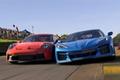 Image of a blue car racing side-by-side with a red Porsche.