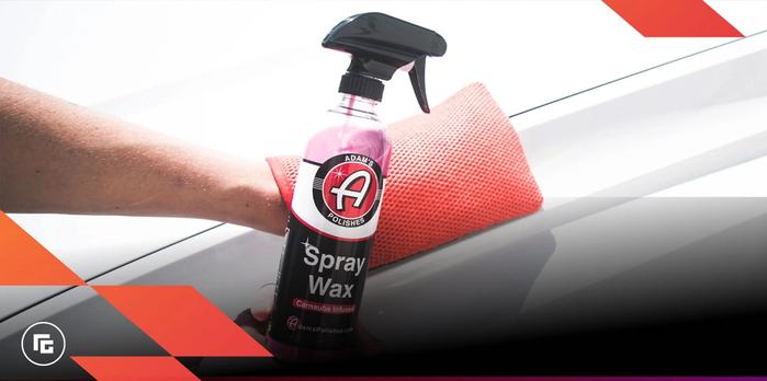 A cleart spray bottle with a black cap featuring red Adam's branding and pink liquid inside..