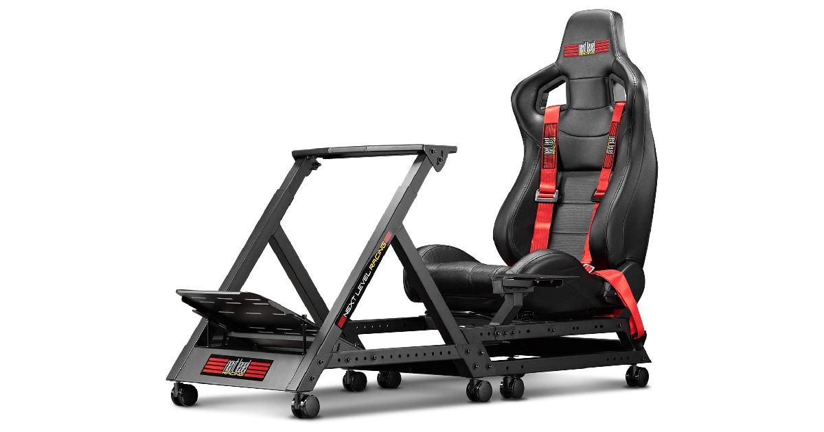 Next Level Racing GT Track Cockpit product image of a black racing seat joined to a wheel and pedal stand, the seat featuring red seat belts.
