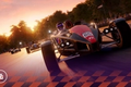 GRID Legends in-game image of a black and red Ariel Atom sports car racing ahead of others on track.
