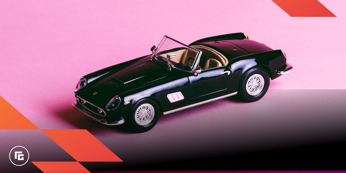 Image of a black covertable model car in front of a pink background.