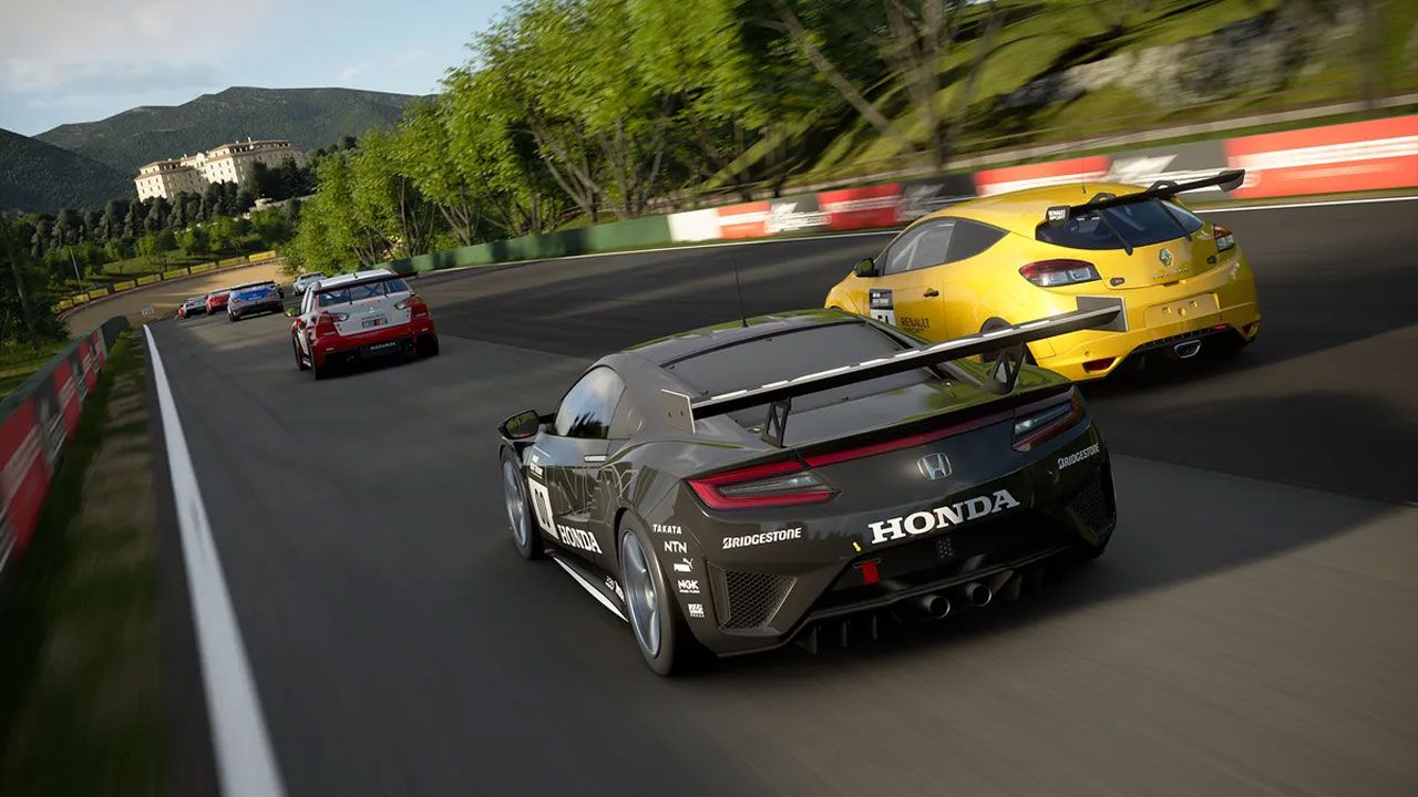 Gran Turismo 7 in-game image of a black Honda racing alongside a yellow Renault behind a group of cars on a track.