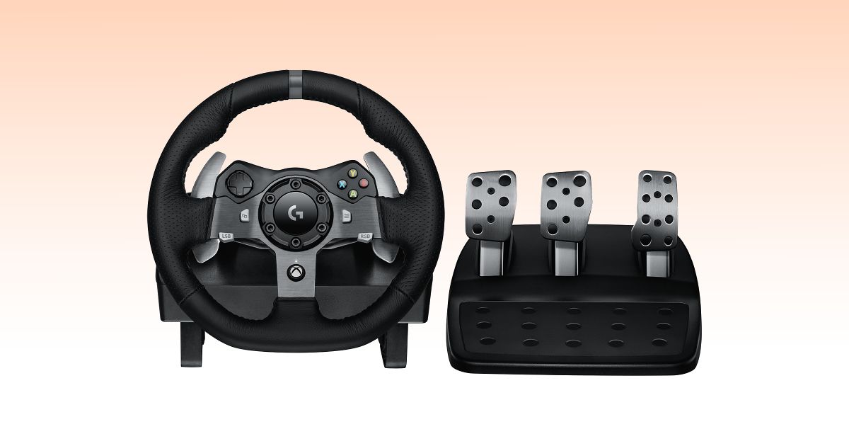 A black racing wheel with a leather cover next to a metal set of pedals.