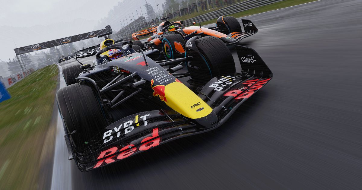 A dark navy Red Bull-branded F1 car with a yellow and red livary racing ahead of the orange and black McLaren.