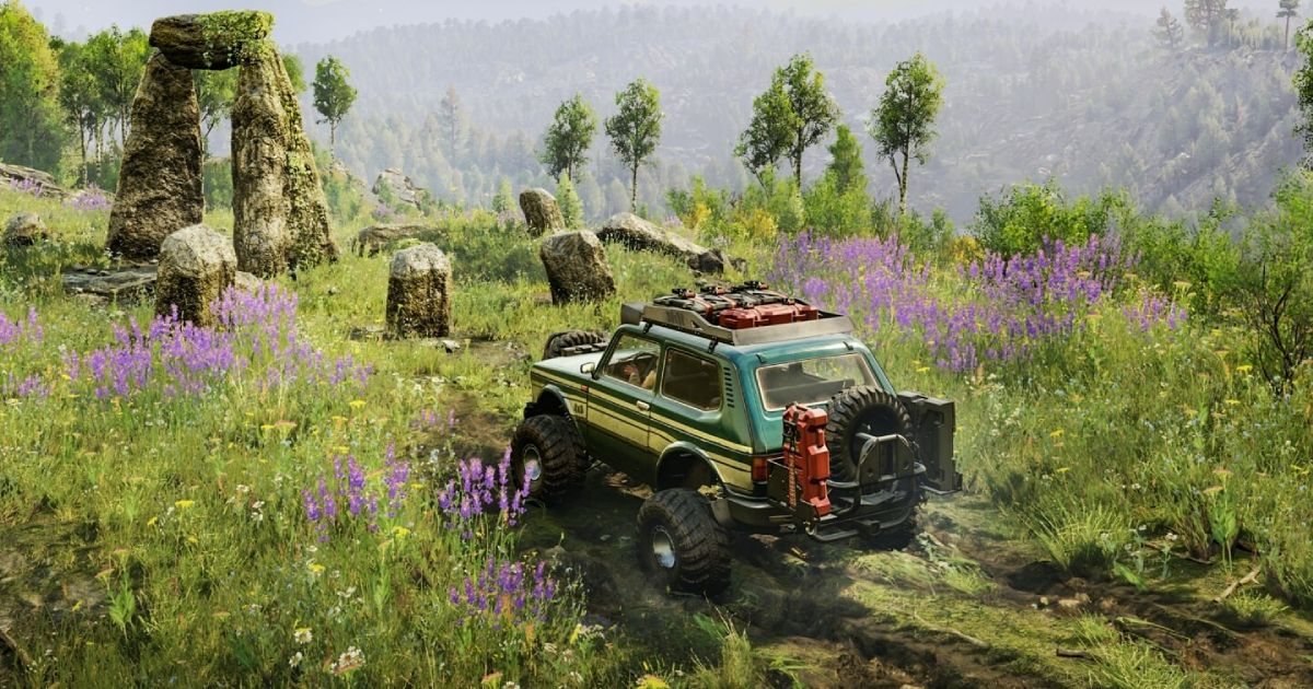 A green off-road vehicle with yellow trim driving through long grass towards some stones in Expeditions: A MudRunner Game.