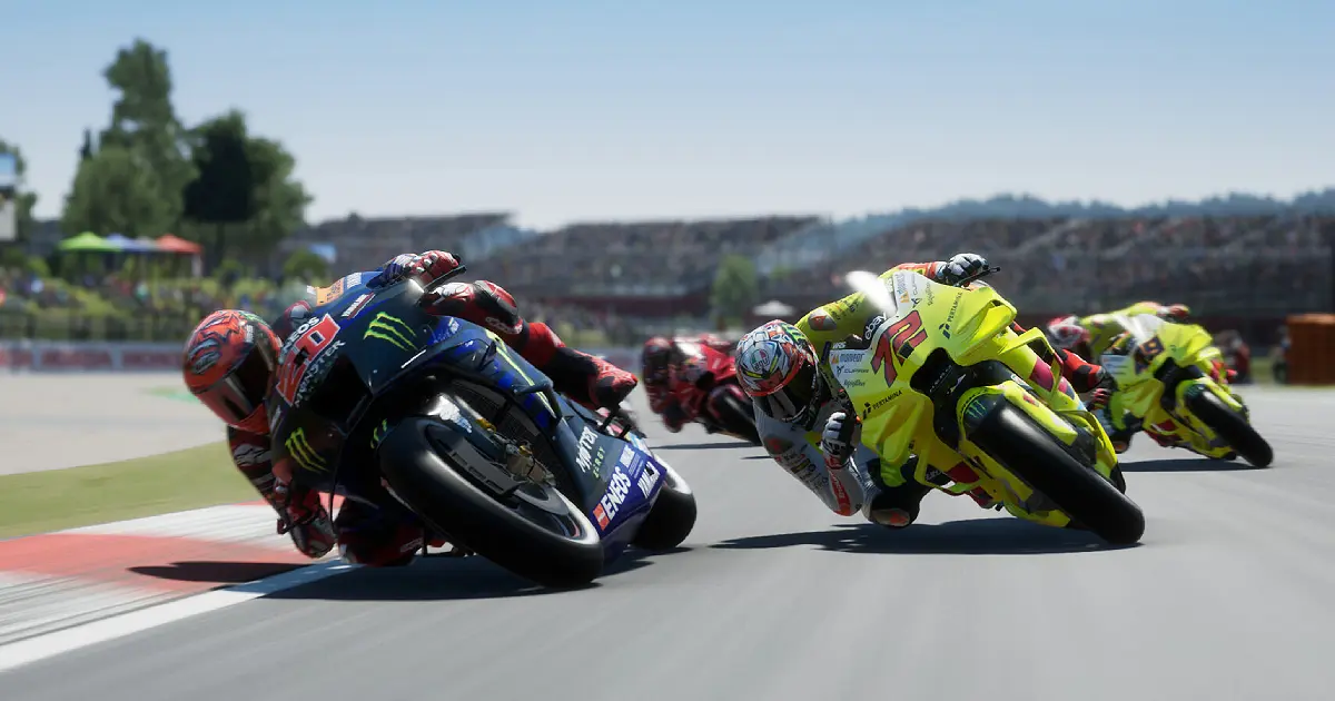 Motorcycles in black and yellow racing close to the curve in MotoGP 24.