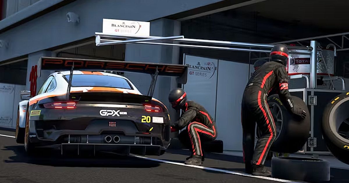Two racing mechanics in black suits with red trim changing the tyre on a black, white, and orange sports car in Assetto Corsa Competizione.