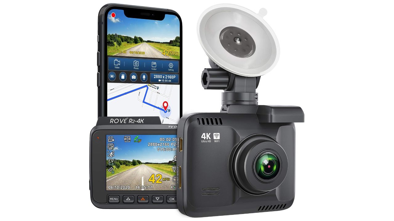 Rove R2-4K product image of a graphite-coloured dash cam with a sticky mounting point next to recorded footage on the rear display and a phone.