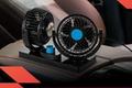 Image of two black car fans with blue centres on the centre console.