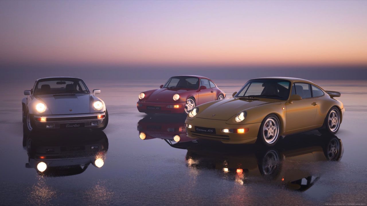 Gran Turismo 7 in-game image of three Porsches lined up in front of a sunset, one in yellow, one in red, and one in white.