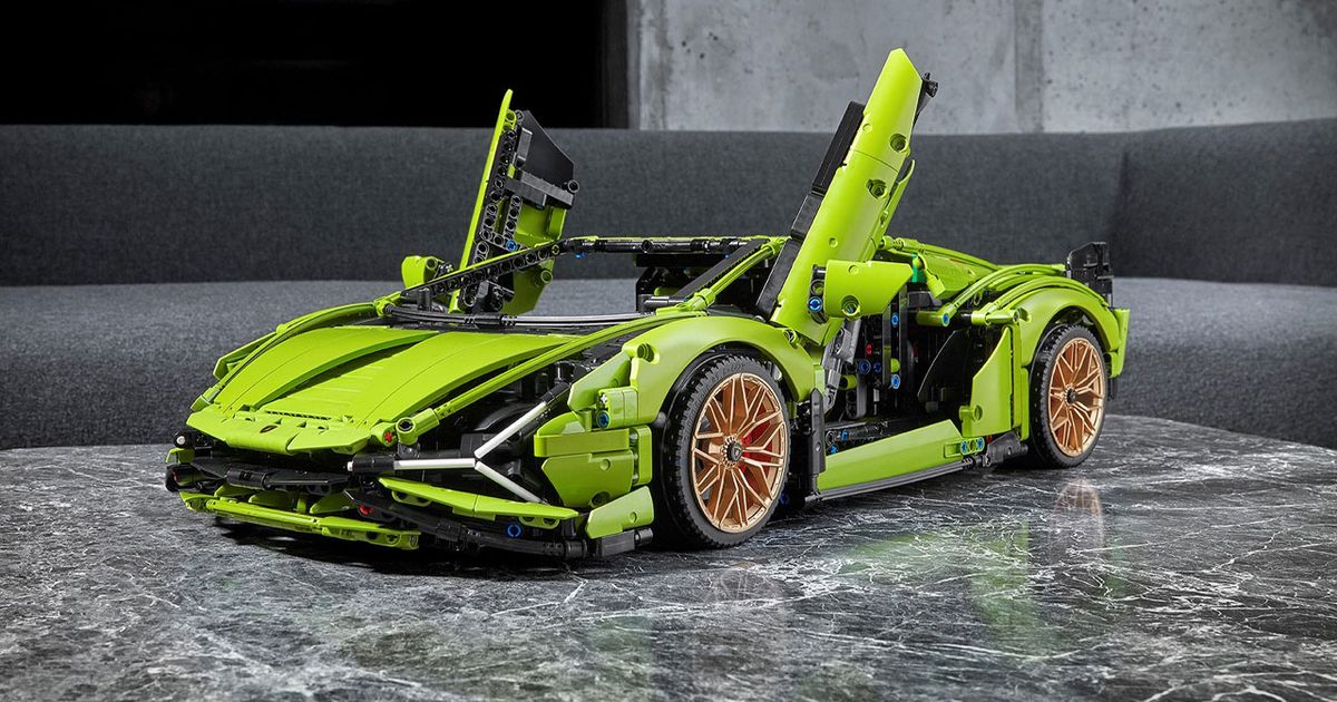 A green Lamborghini made out of LEGO placed on a grey table.