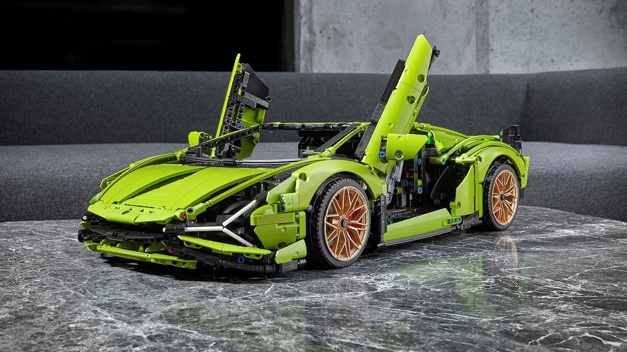 A green Lamborghini made out of LEGO placed on a grey table.