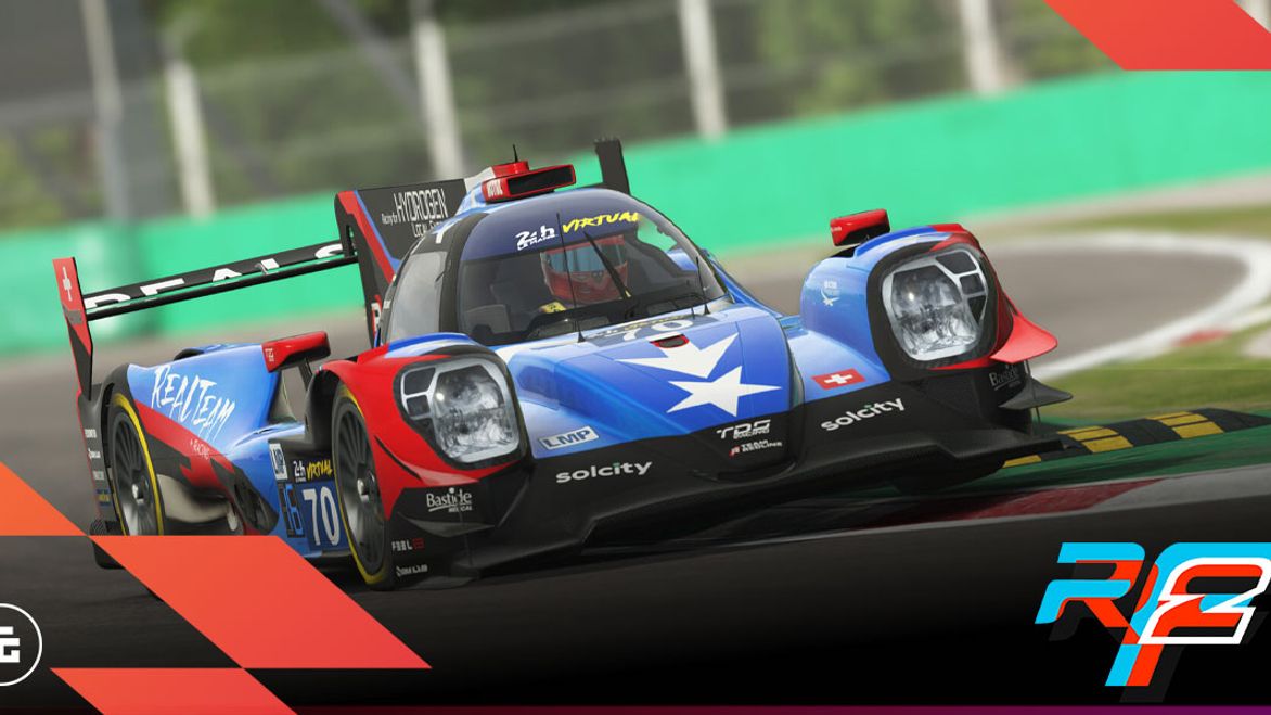 In-game image from rFactor 2 of a blue, red, and black car with a spoiler racing on a track.