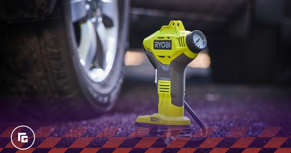 Image of a green and grey tyre inflator featuring a light next to a car's wheel.