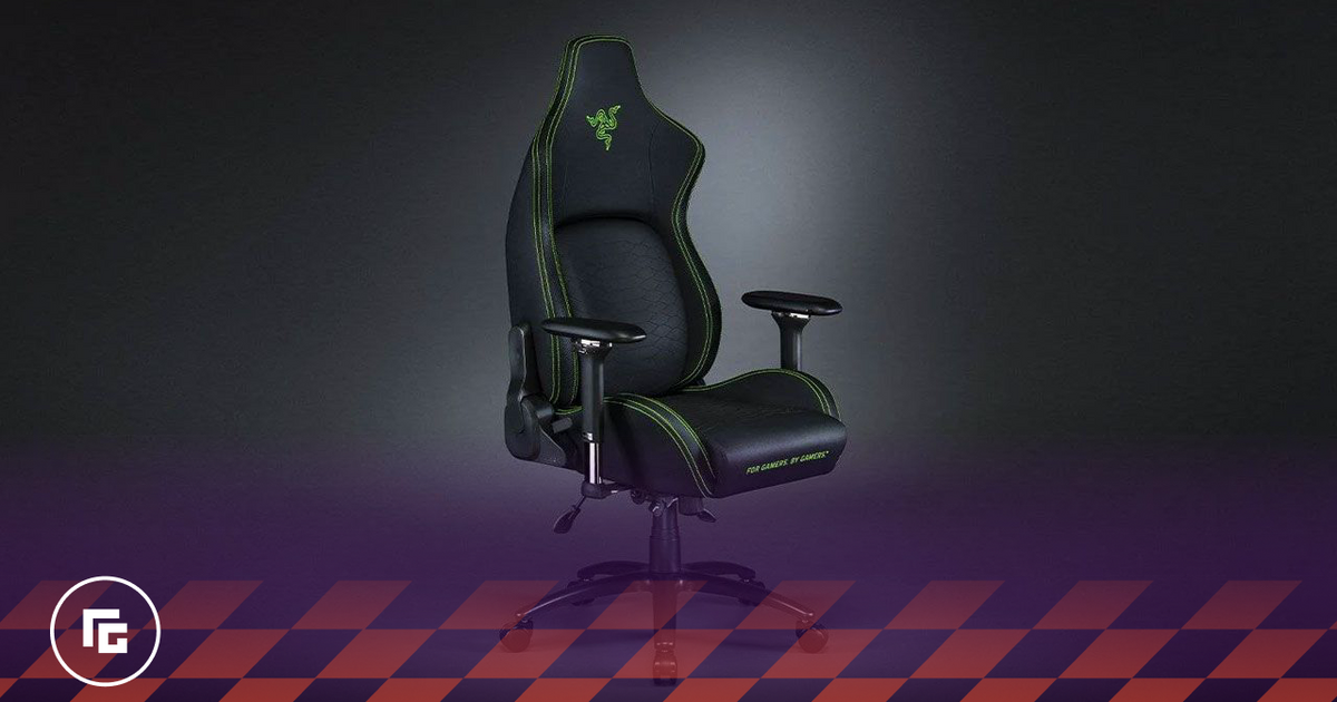 A black gaming chair with green branding and stitching in a dark grey room.