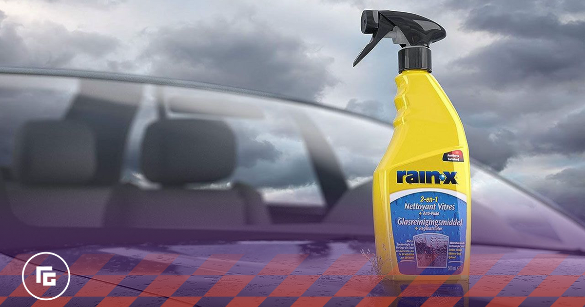 A yellow bottle with a black spray cap and blue branding sat on the bonnet of a car.