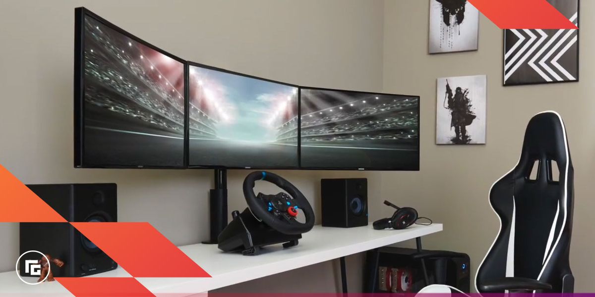 Image of a triple monitor setup with a racing wheel in front.