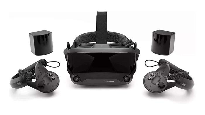 Best racing VR headset - Valve Index product image of a black VR headset next to a set of controllers and sensors.