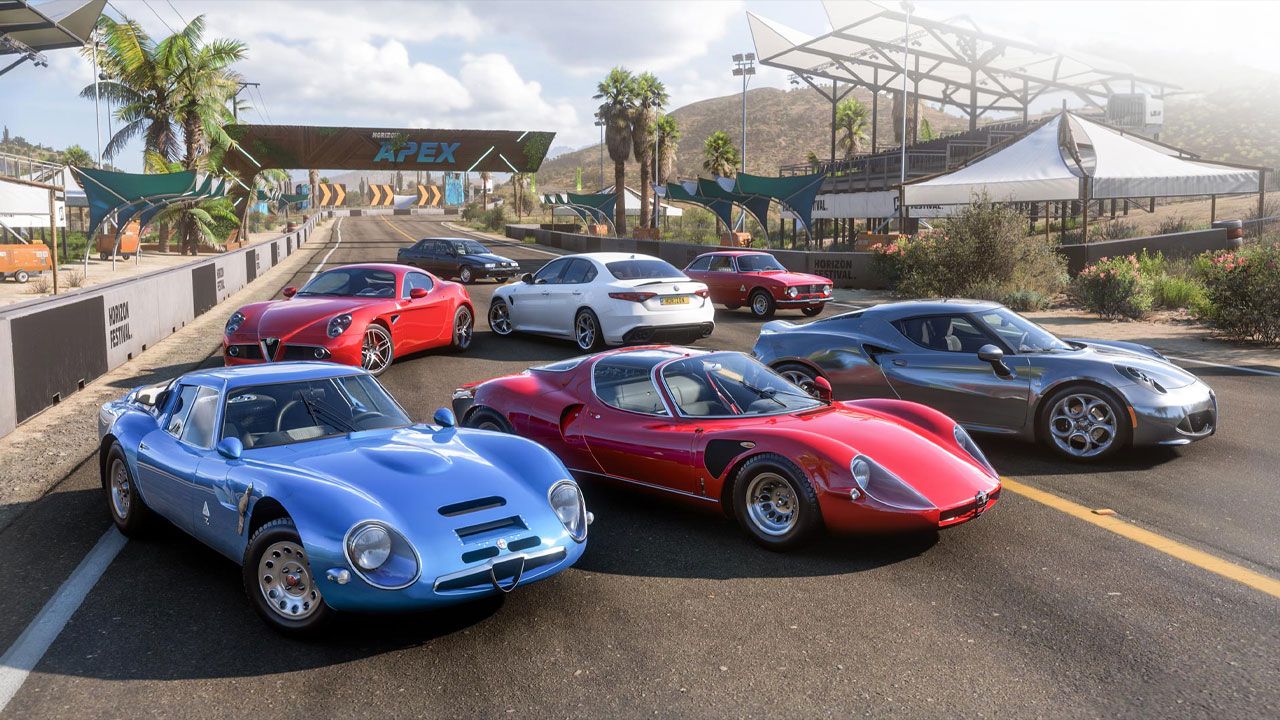 Forza Horizon 5 in-game image of a group of cars, icnlduing a blue, red, and silver vehicle at the front, on a track.